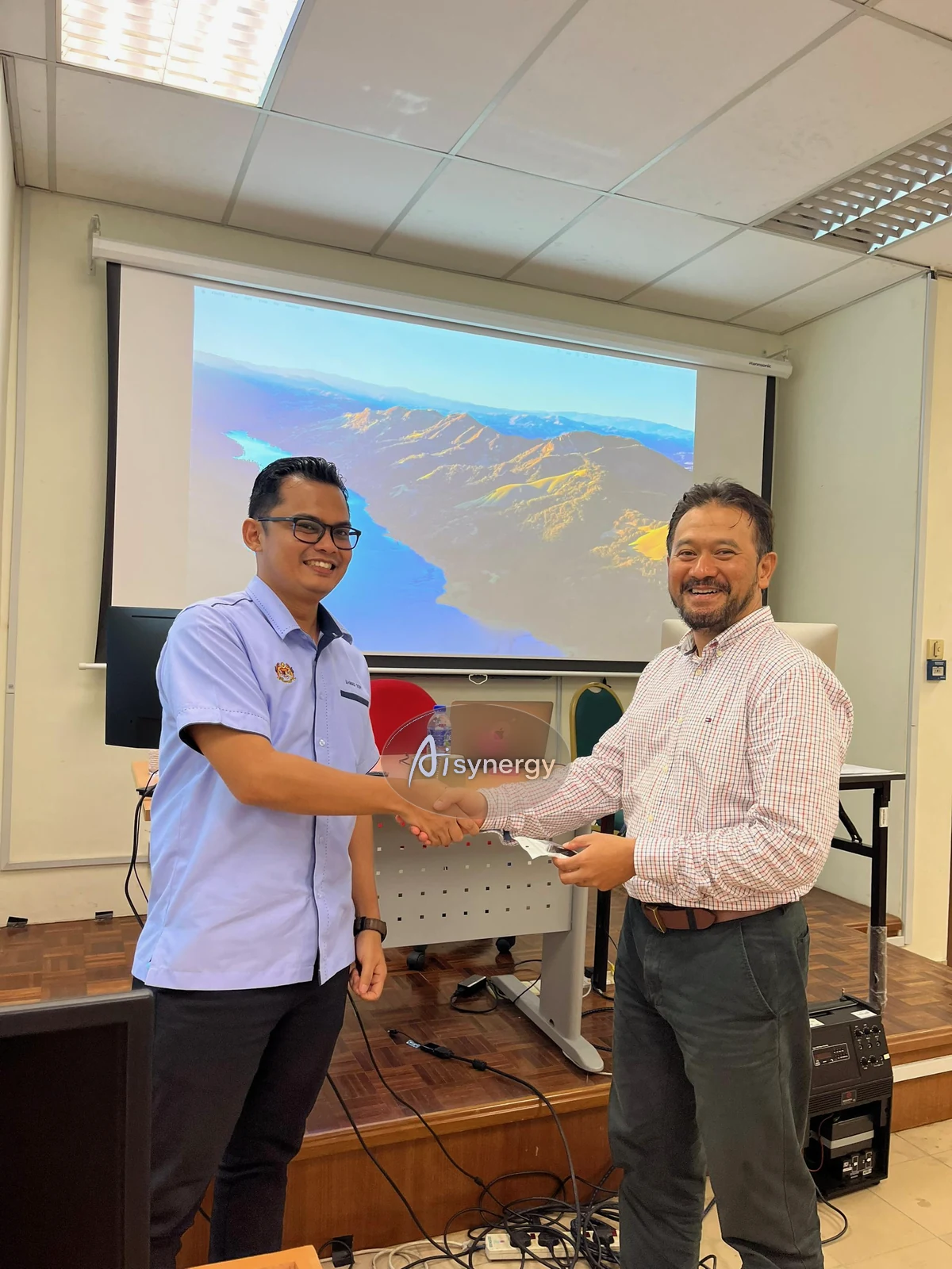 AISynergy trainer and a participant shaking hands at the close of a session