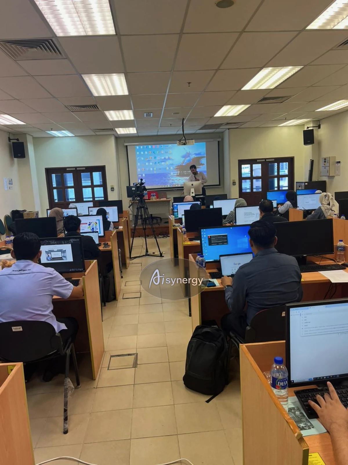 AISynergy trainer presenting at the front of a computer-lab session