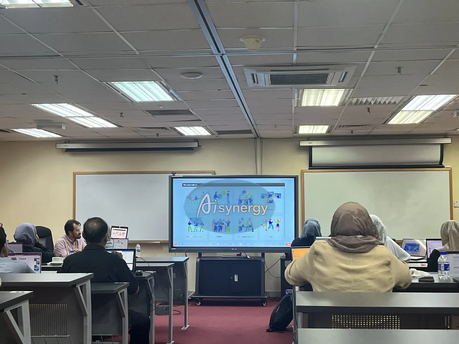 Participants following a demonstration on the room’s main screen