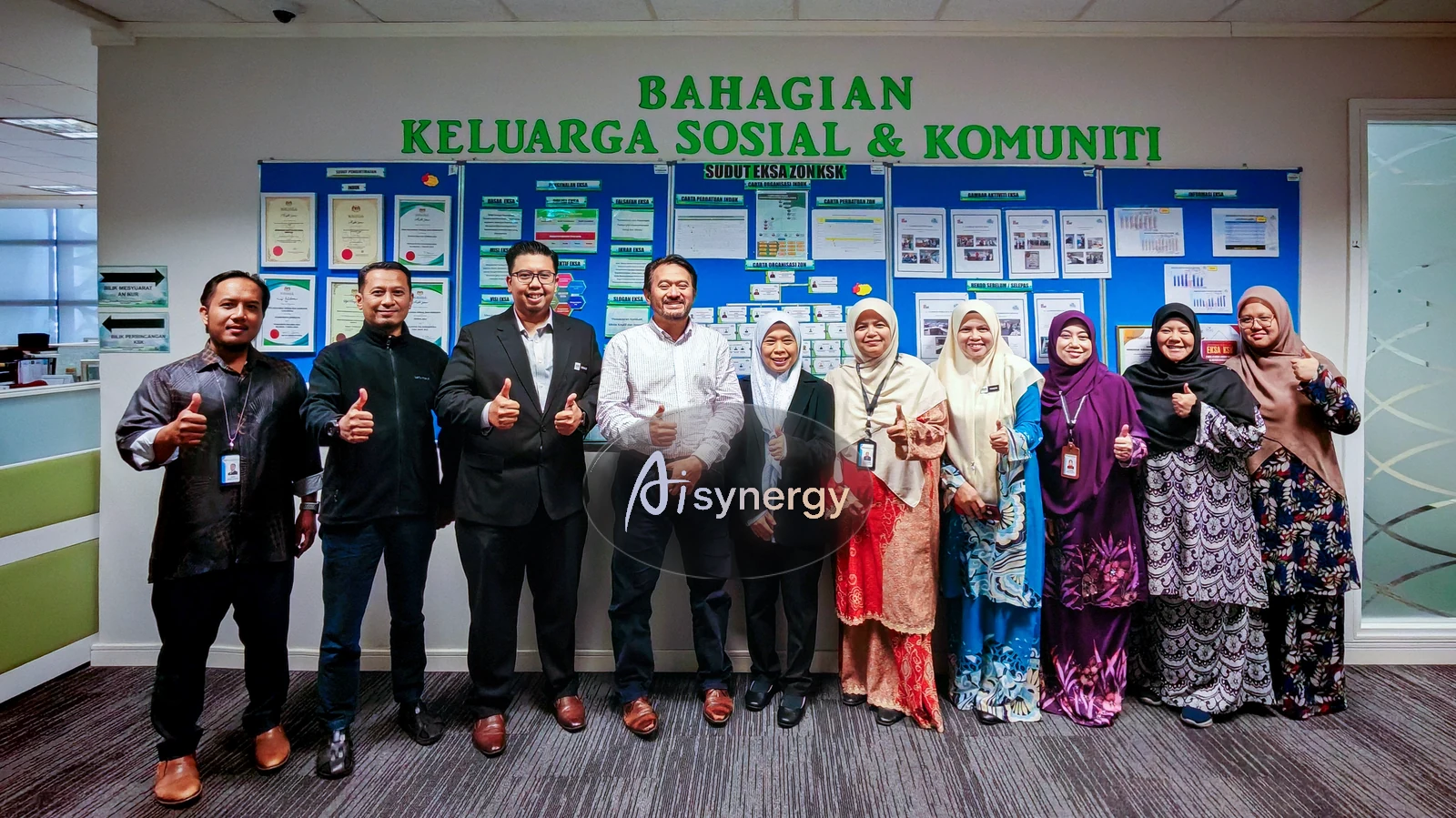 AISynergy trainer and a department team posing together in their own office after a session
