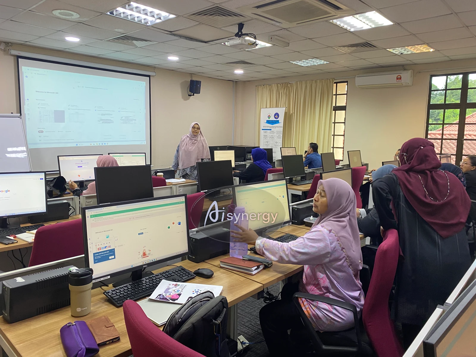 AISynergy trainer presenting at the front of a computer-lab session